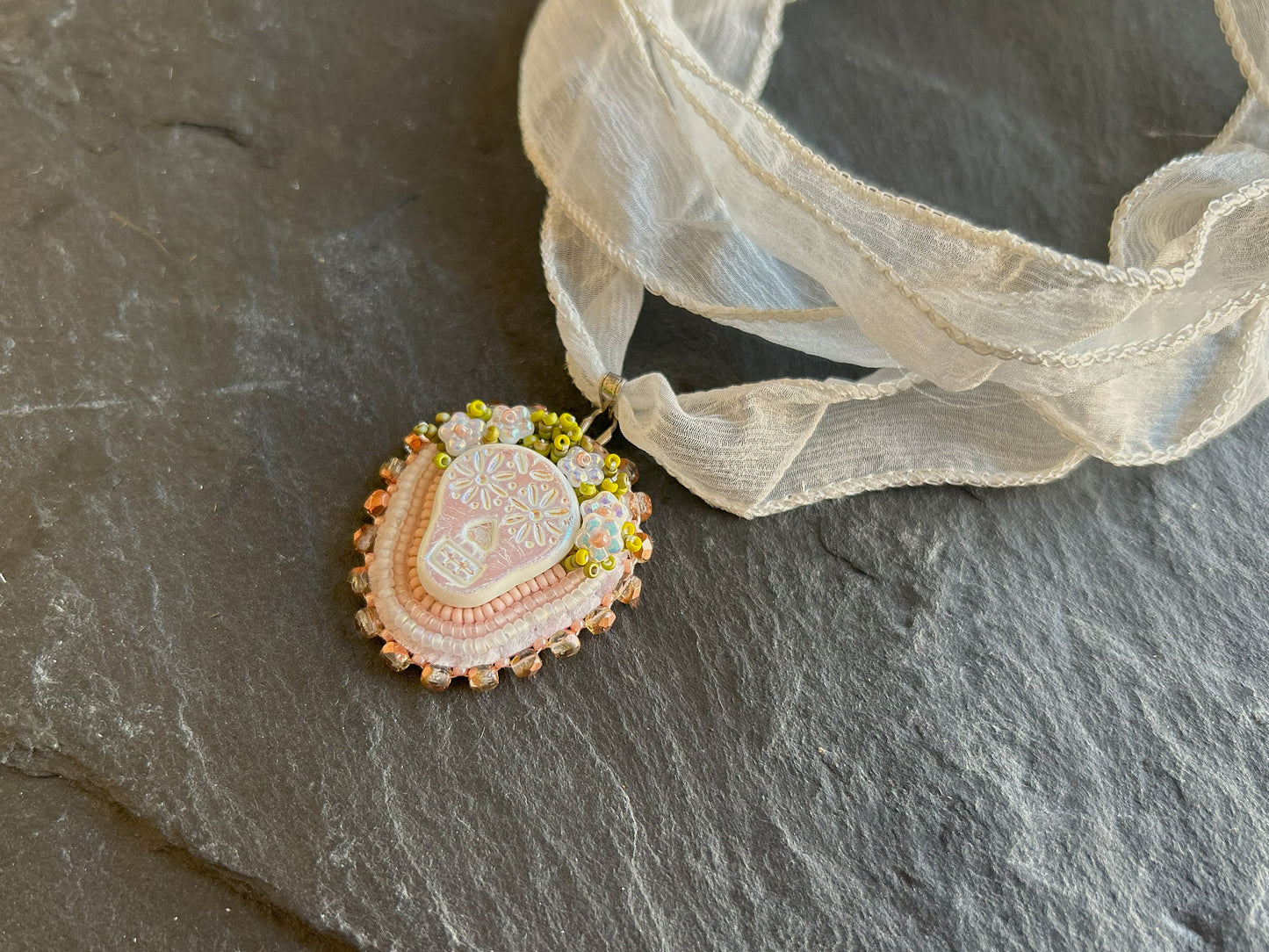 "Tuwile" necklace pendant - skull wearing a flower crown in white & pastel shades