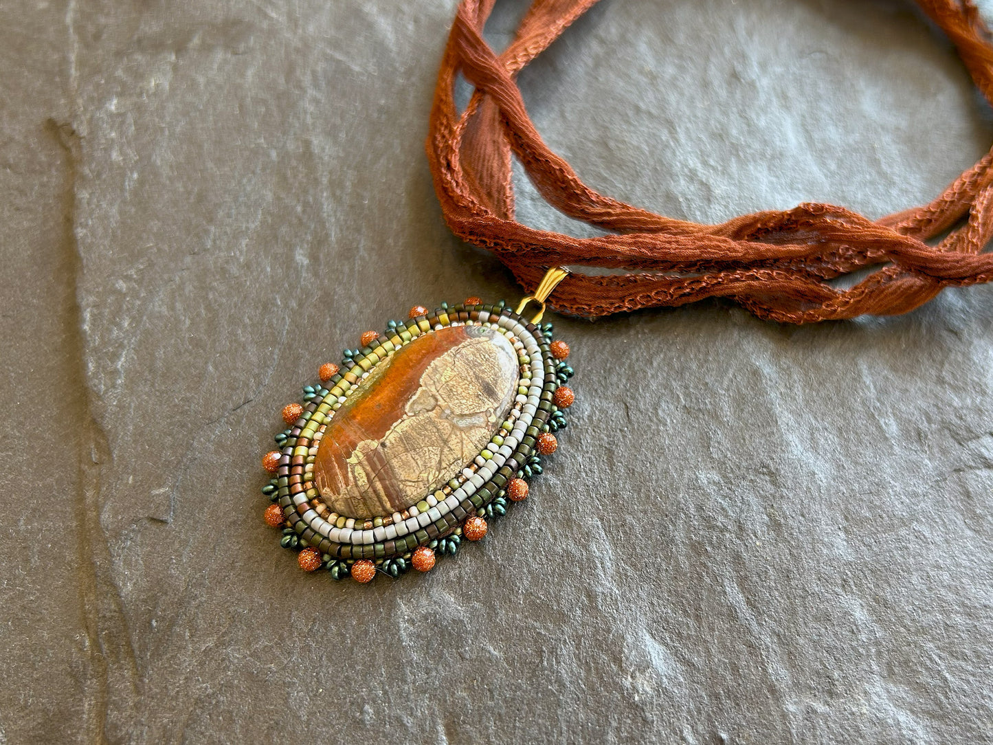Scenic jasper necklace pendant with goldstone beads