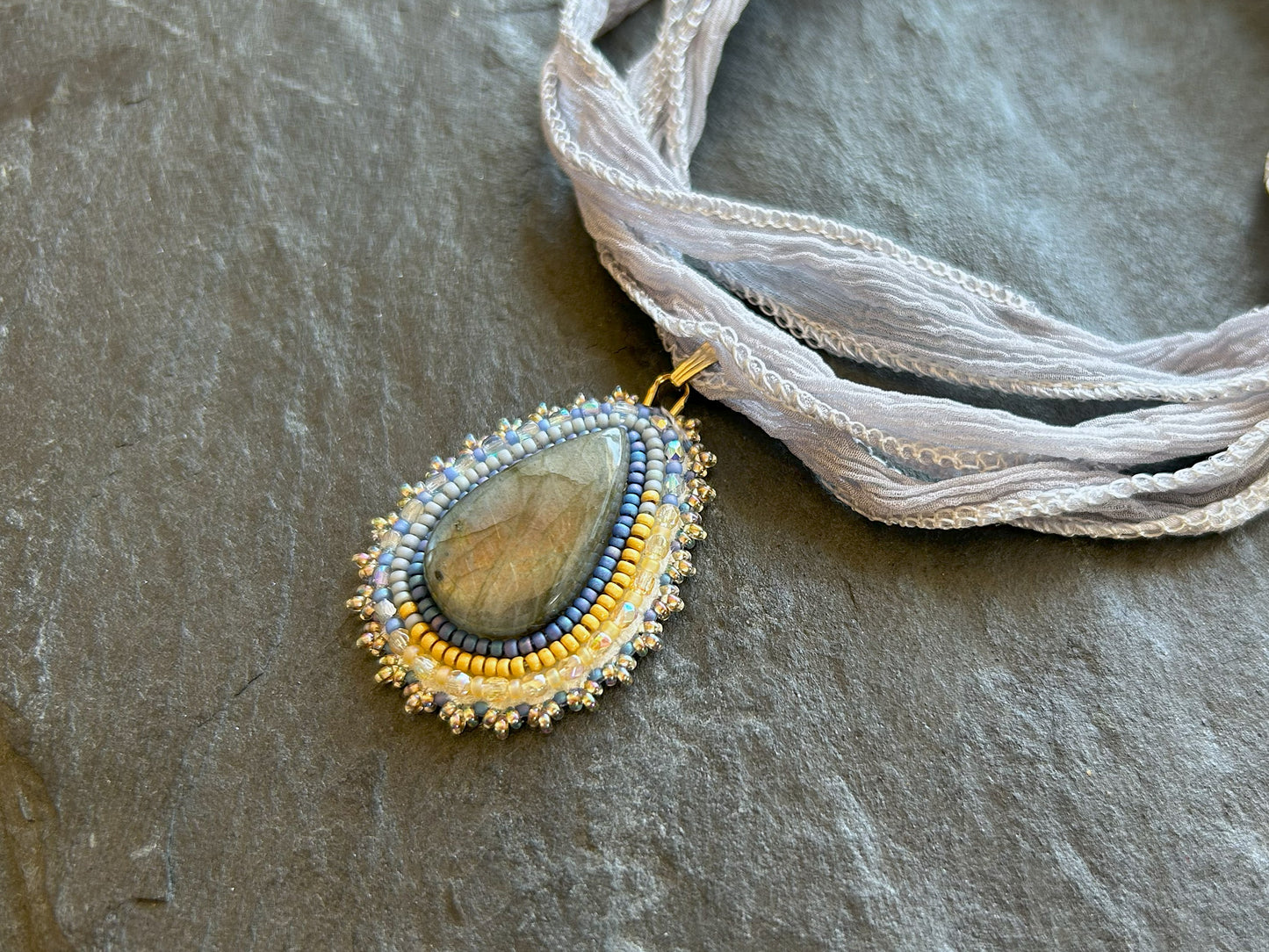 Small labradorite necklace pendant with blue to yellow fire