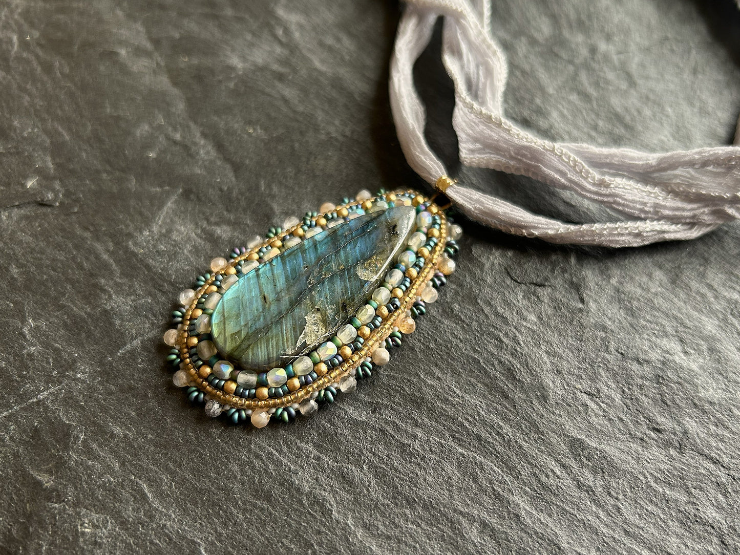 Striped labradorite necklace pendant with deep blue fire