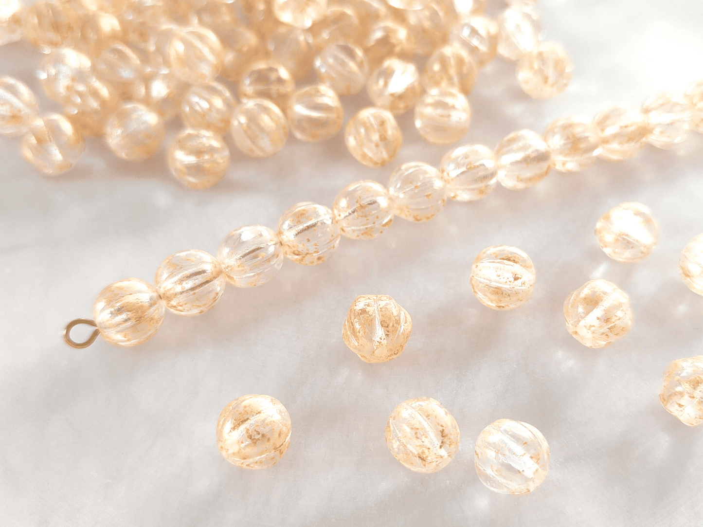 Melon beads 8mm - colorless & gold speckles