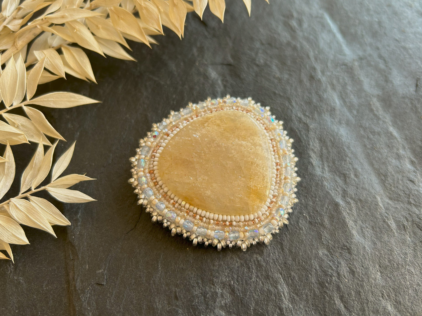 Belomorite brooch with light blue fire