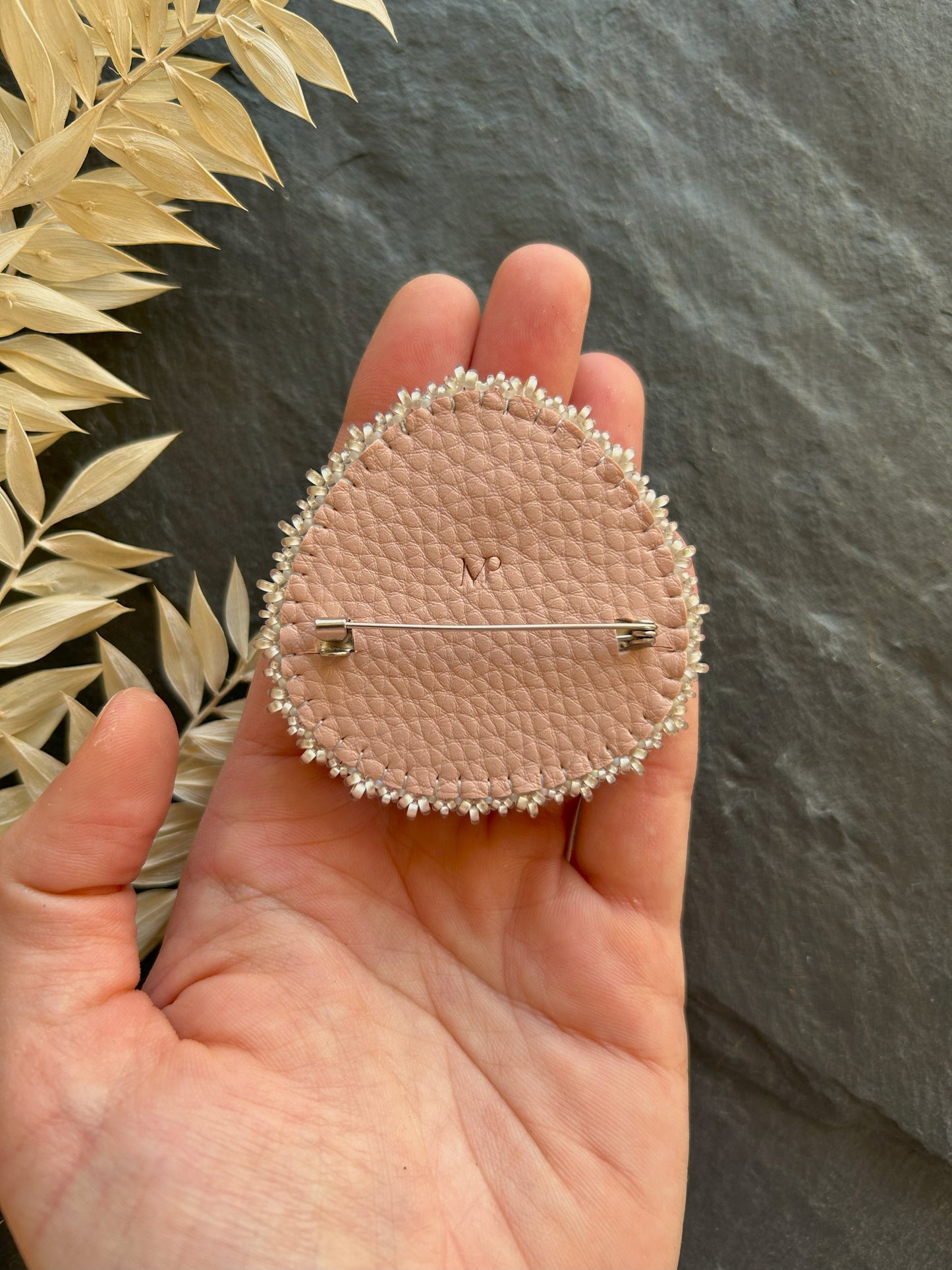 Belomorite brooch with light blue fire