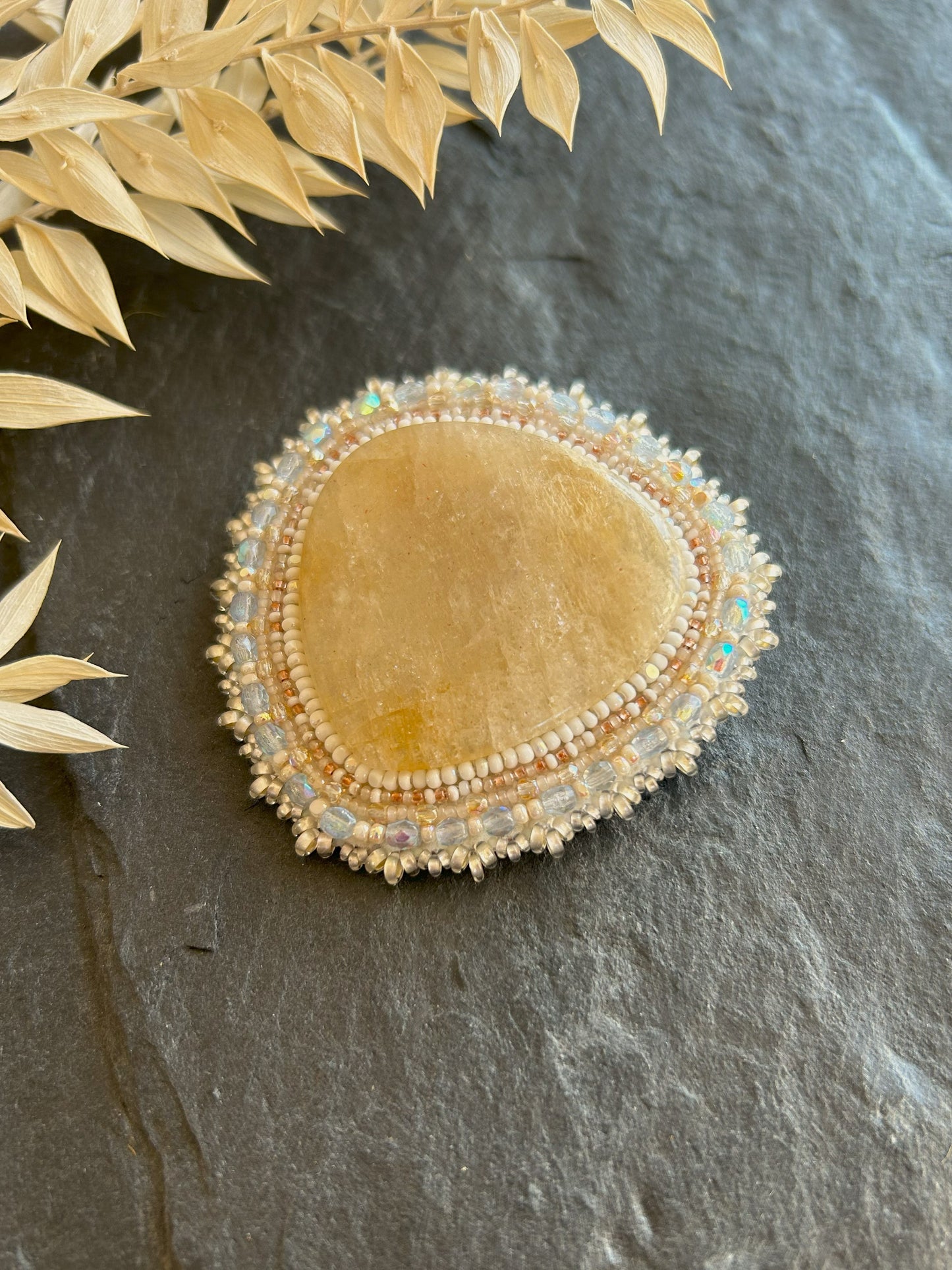 Belomorite brooch with light blue fire