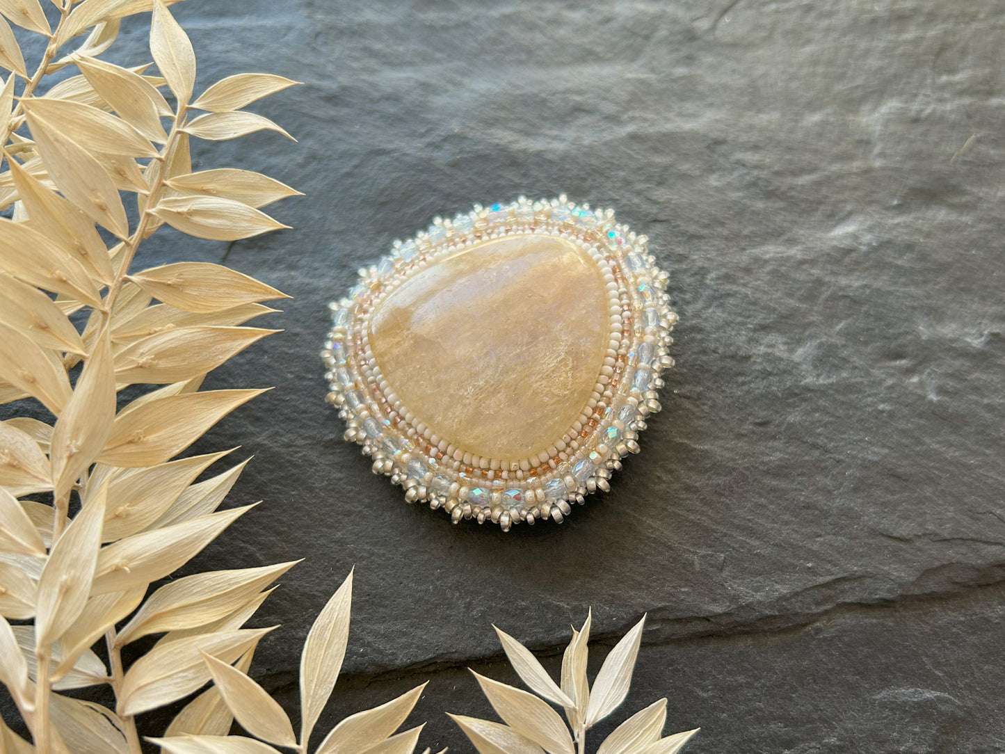 Belomorite brooch with light blue fire