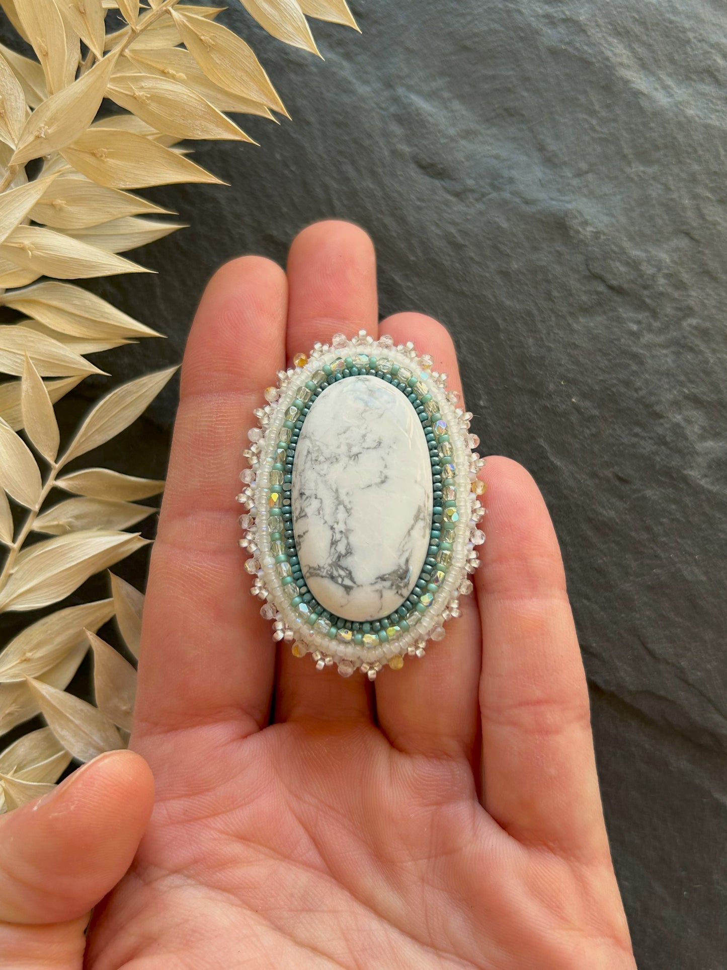 Howlite brooch with rutilated quartz