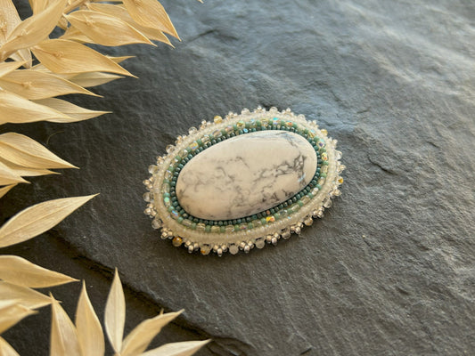 Howlite brooch with rutilated quartz