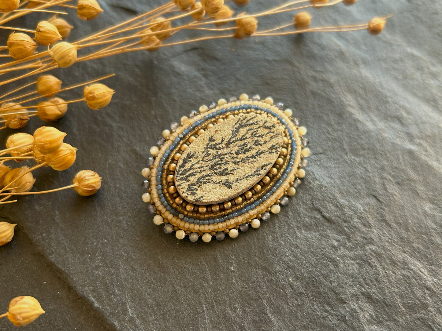 Dendritic psilomelane brooch with shell and water sapphire beads