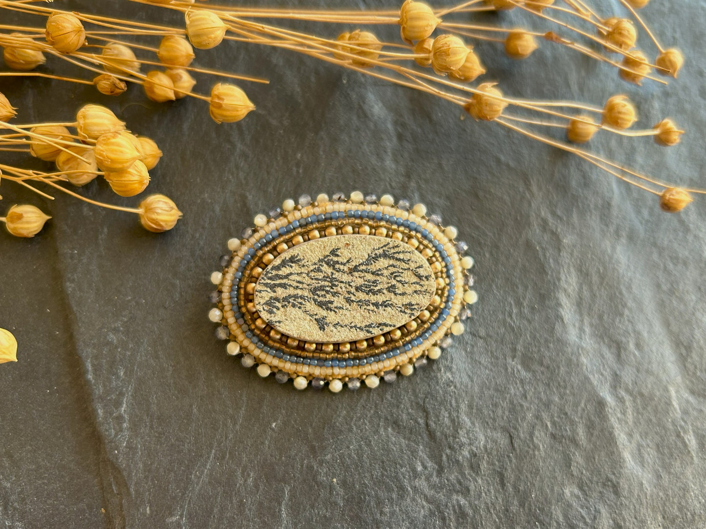 Dendritic psilomelane brooch with shell and water sapphire beads