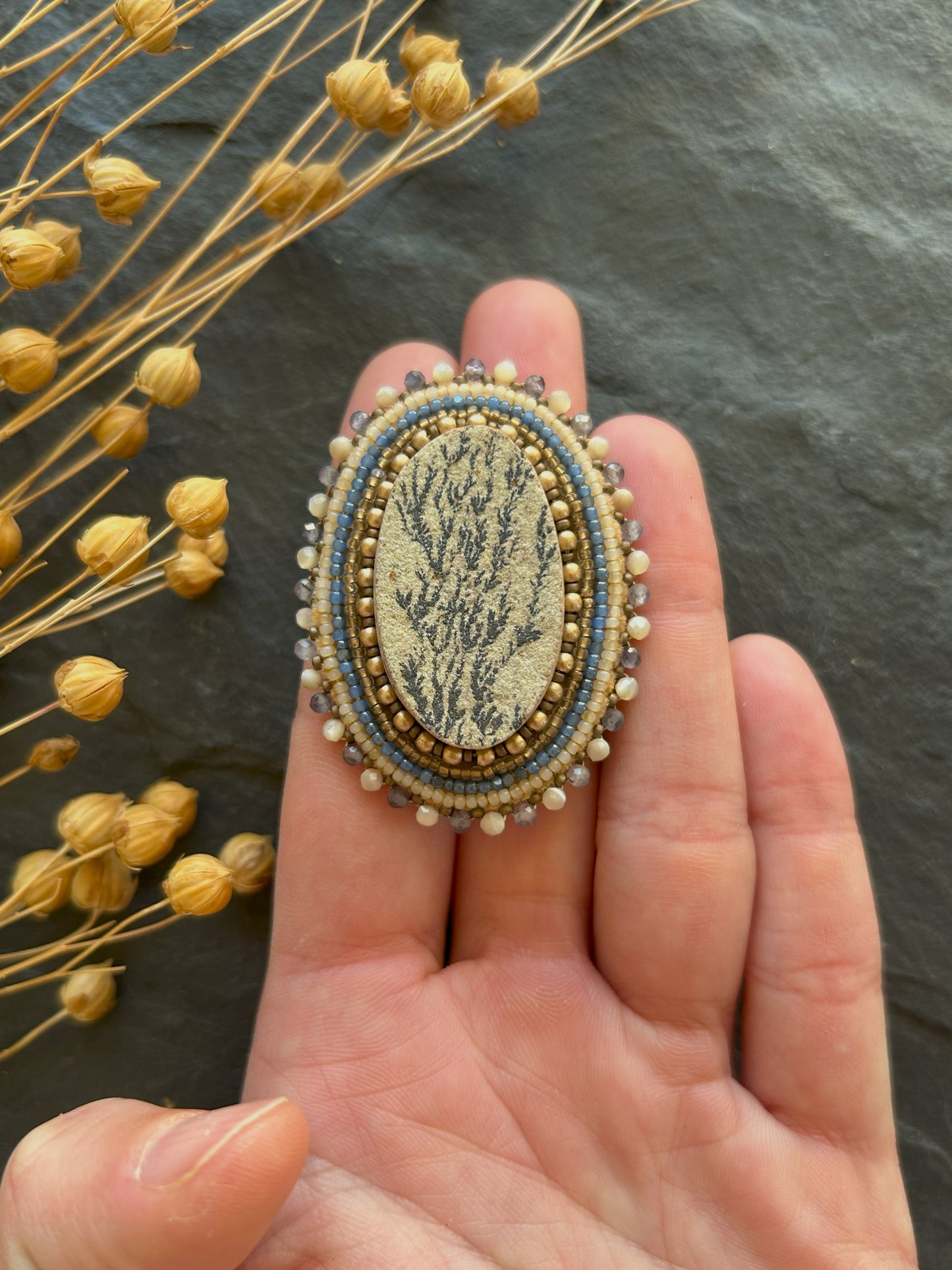 Dendritic psilomelane brooch with shell and water sapphire beads