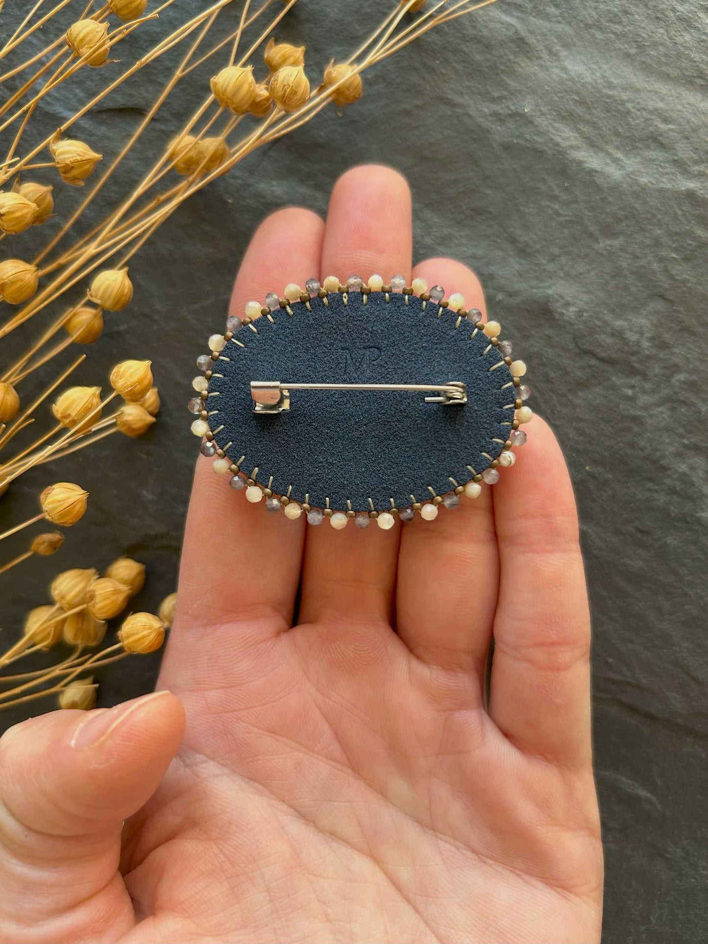 Dendritic psilomelane brooch with shell and water sapphire beads