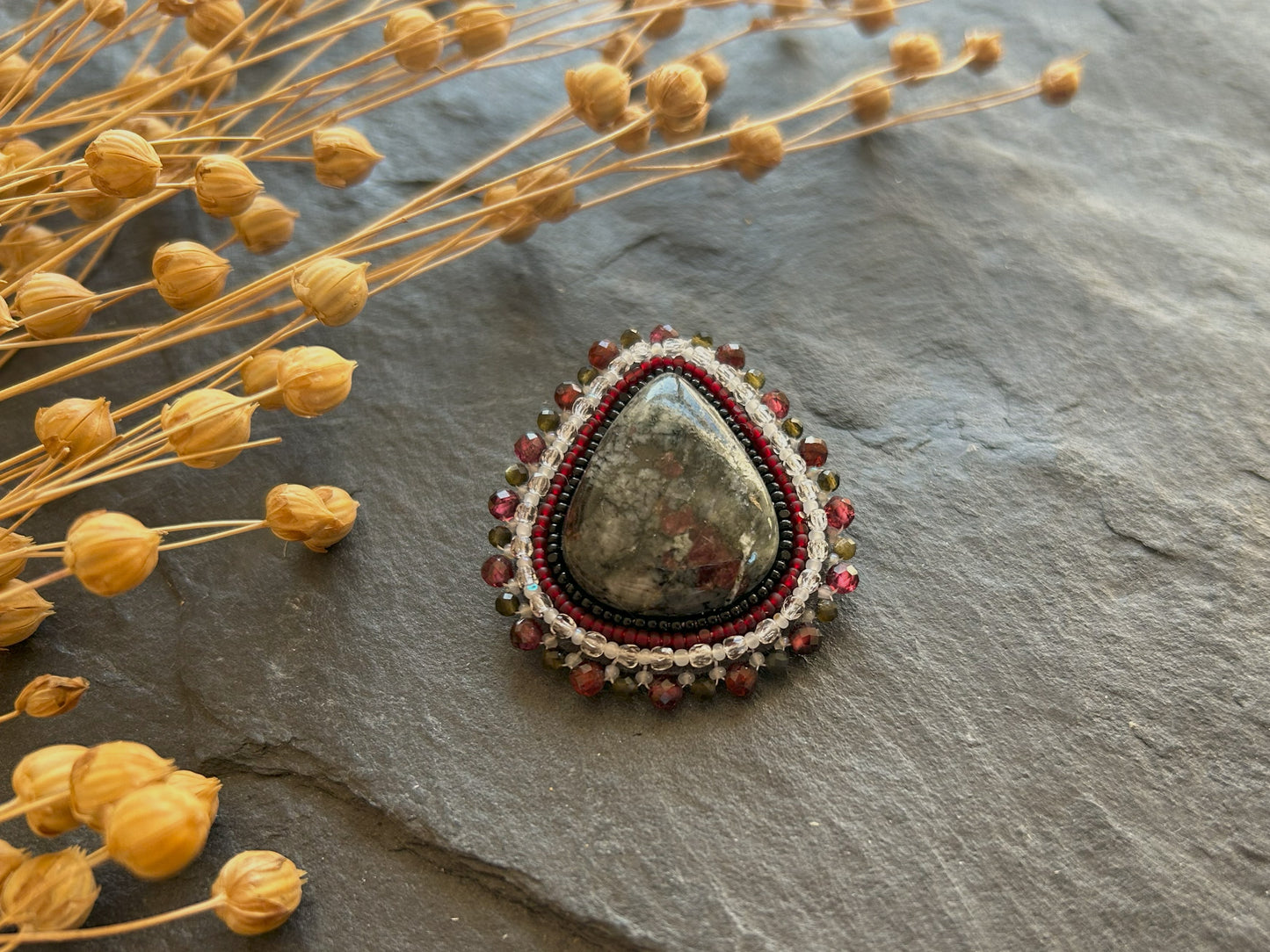 Eydialyte brooch with garnet and obsidian
