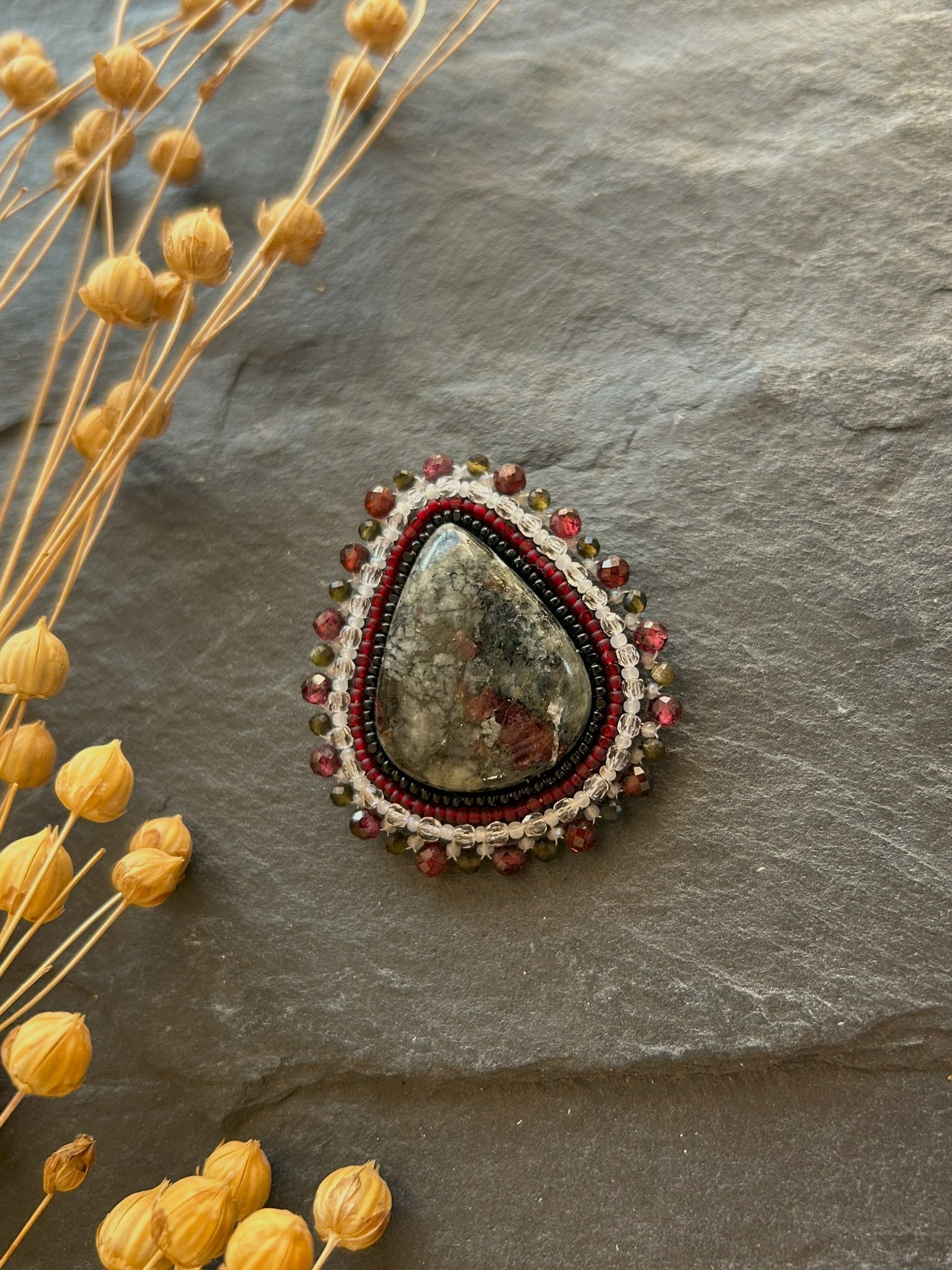 Eydialyte brooch with garnet and obsidian