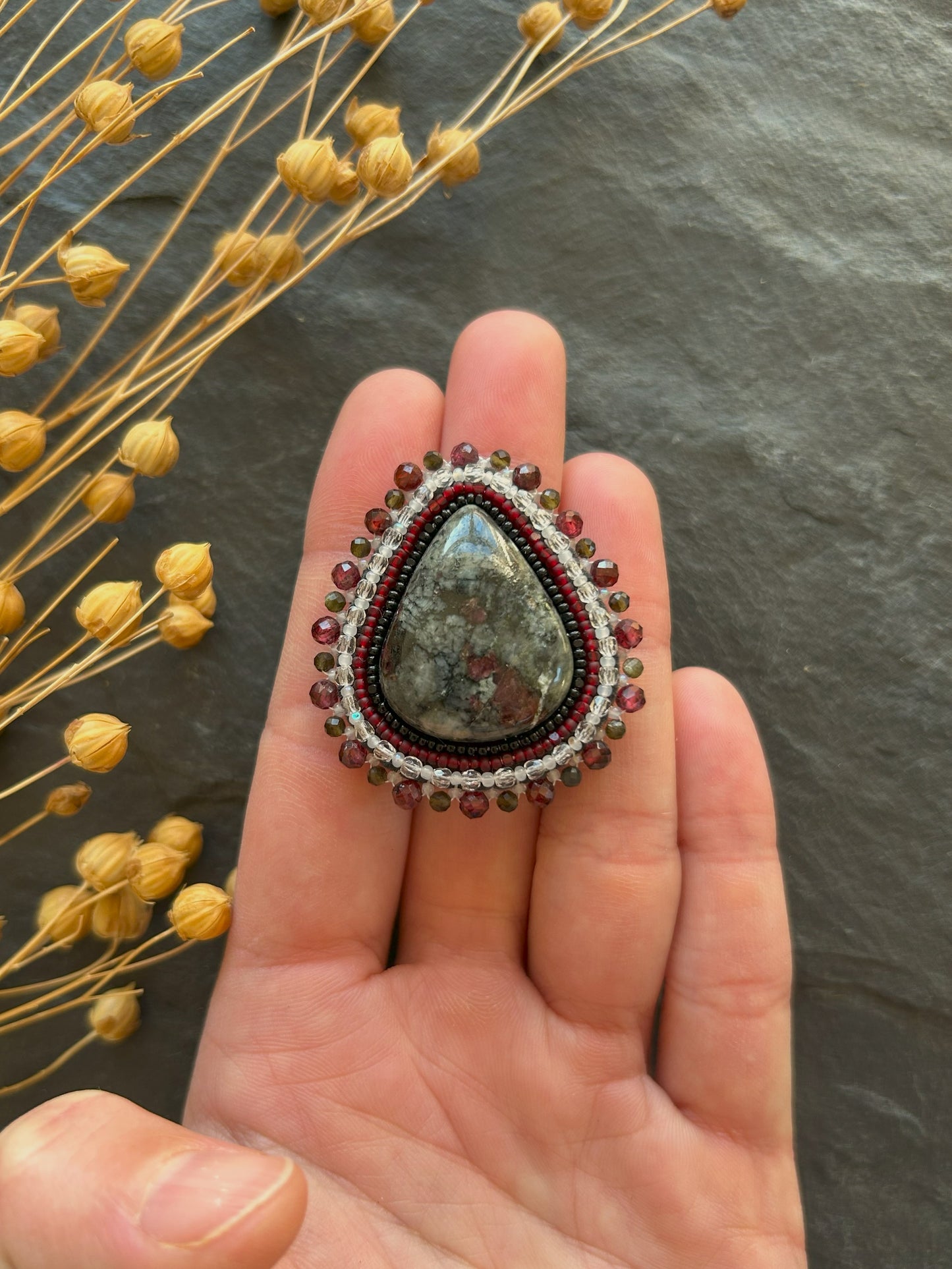 Eydialyte brooch with garnet and obsidian