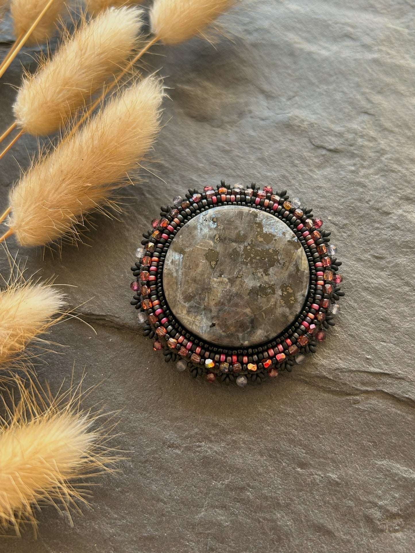 Larvikite brooch with water sapphire and garnet