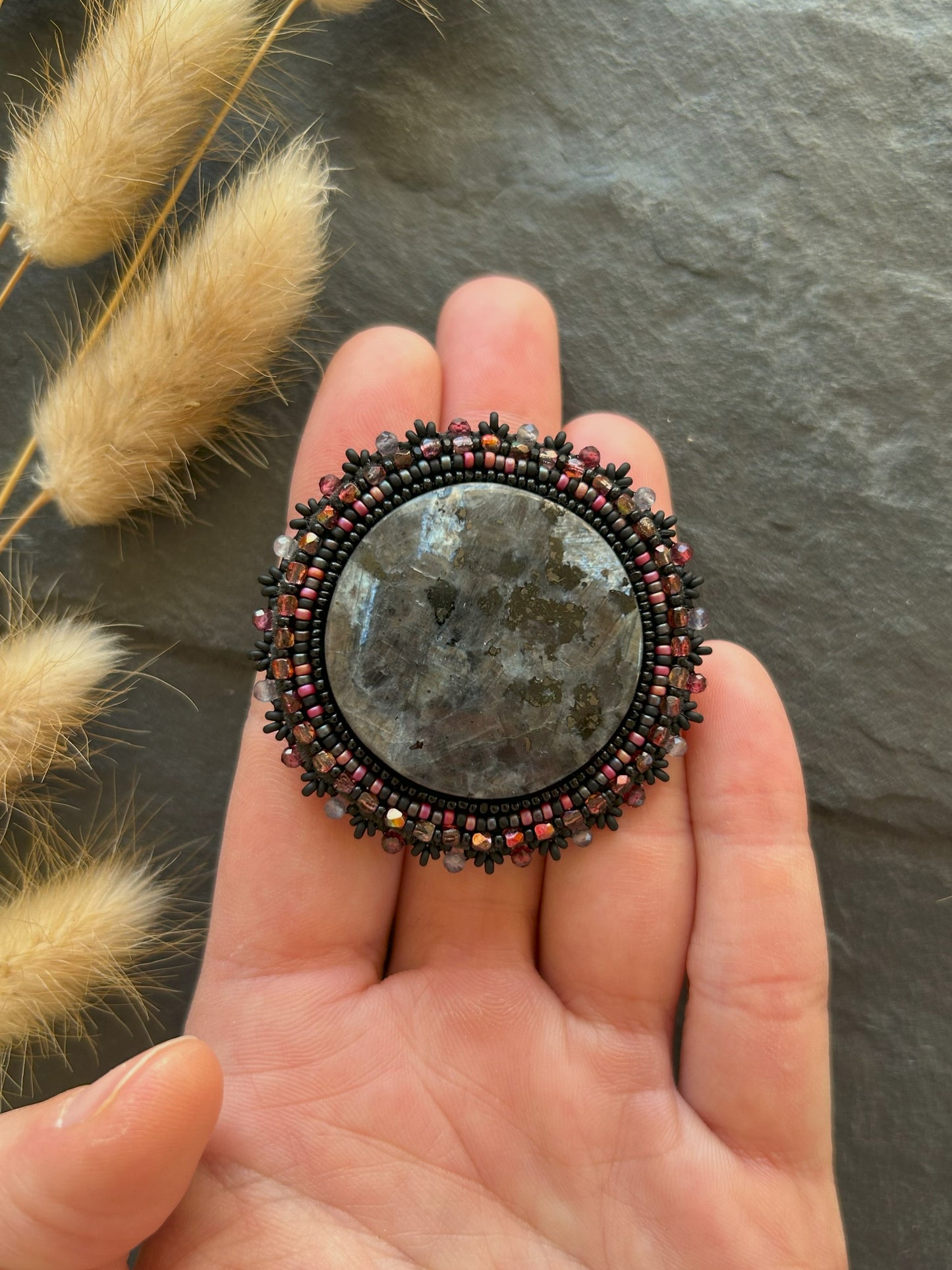 Larvikite brooch with water sapphire and garnet