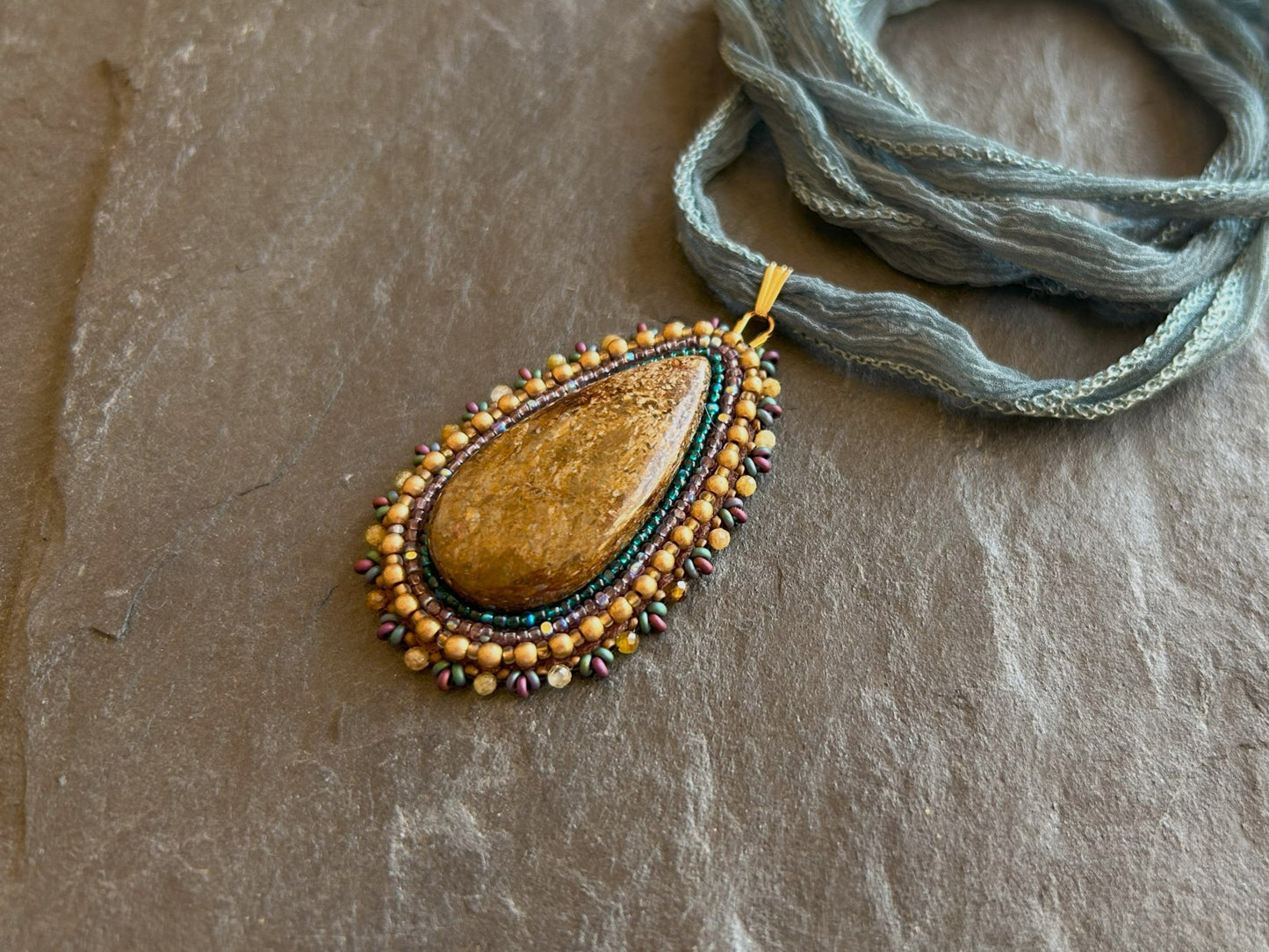 Bronzite necklace pendant with garnet beads