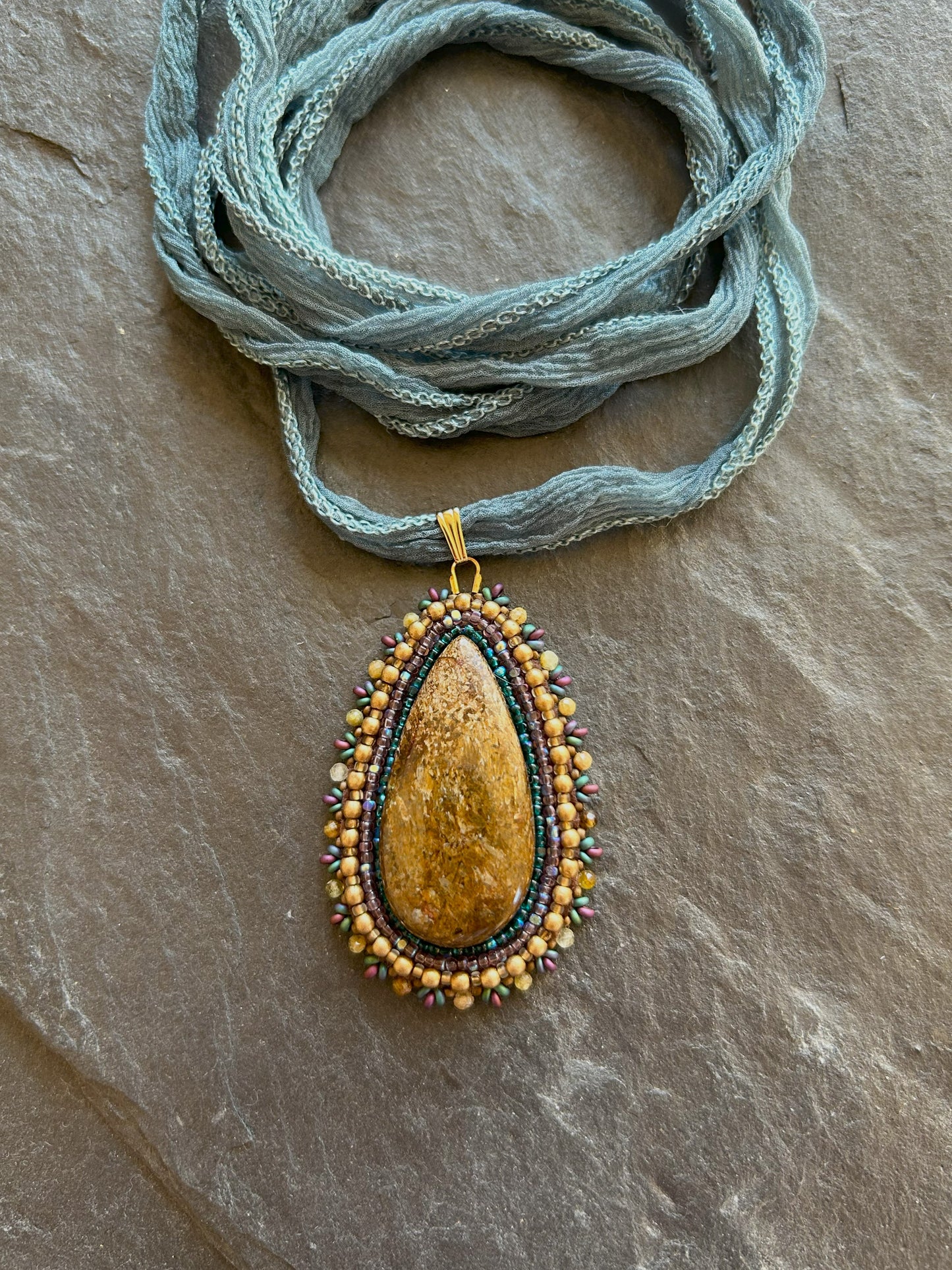 Bronzite necklace pendant with garnet beads
