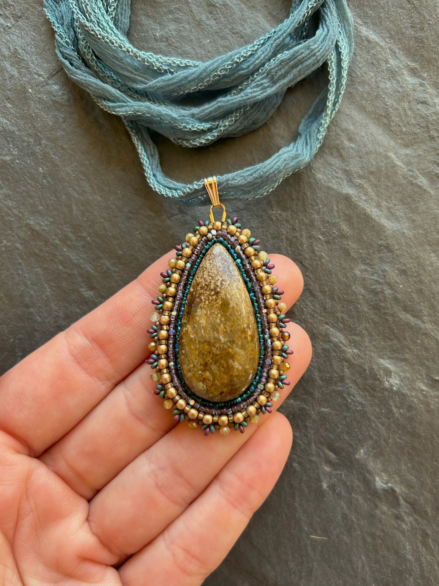 Bronzite necklace pendant with garnet beads
