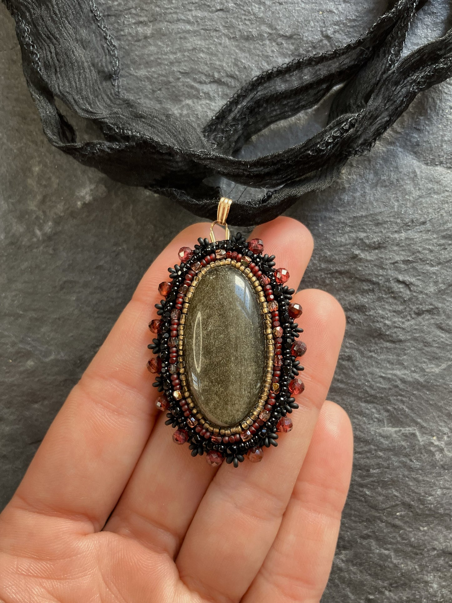 Golden onyx necklace pendant with garnet beads