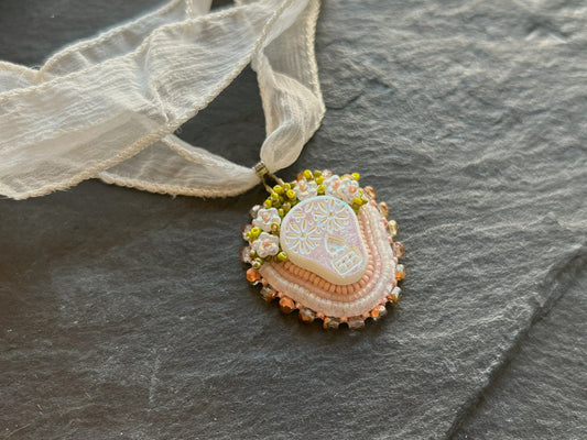 "Tuwile" necklace pendant - skull wearing a flower crown in white & pastel shades