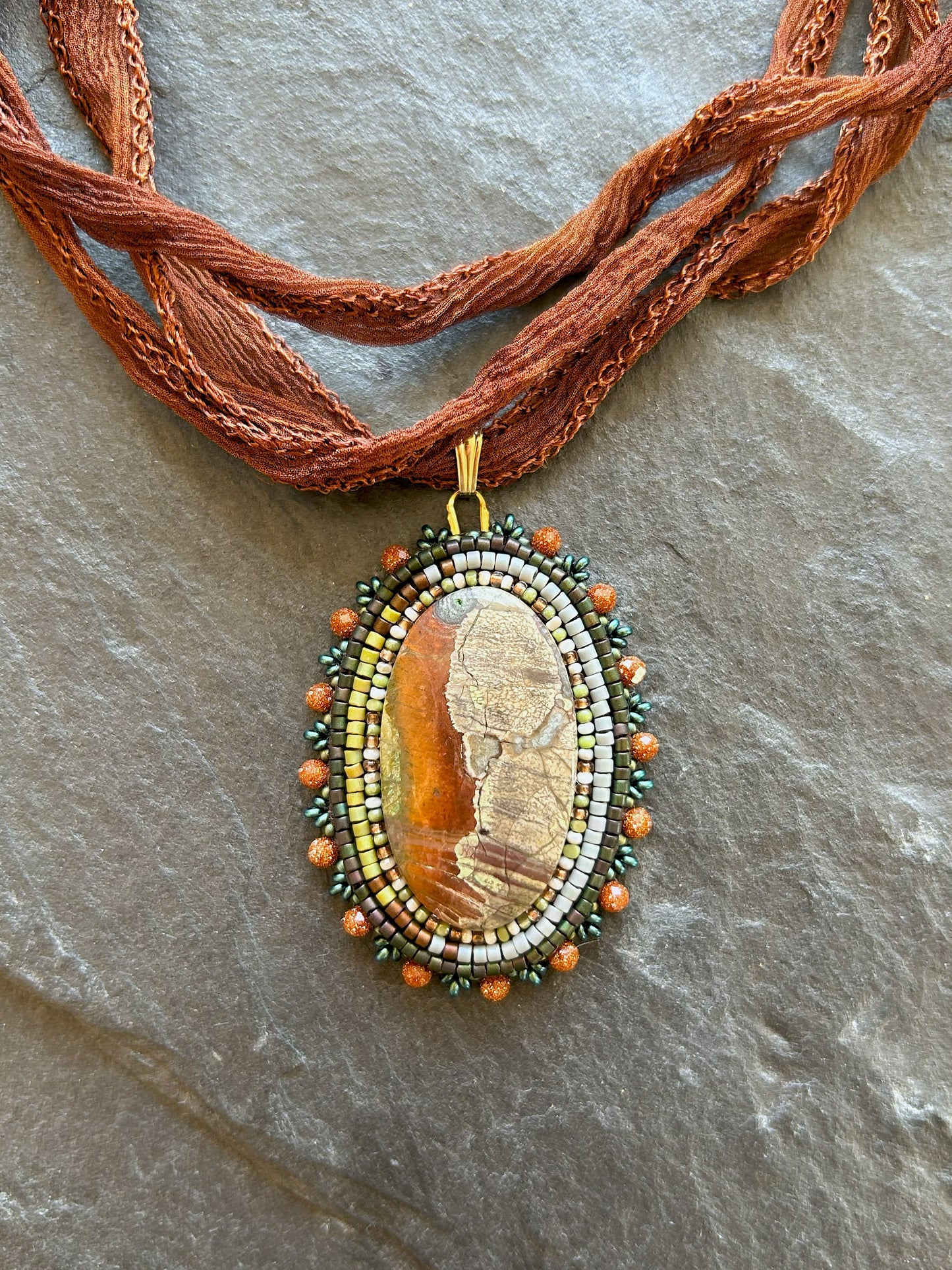 Scenic jasper necklace pendant with goldstone beads