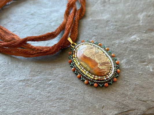 Scenic jasper necklace pendant with goldstone beads