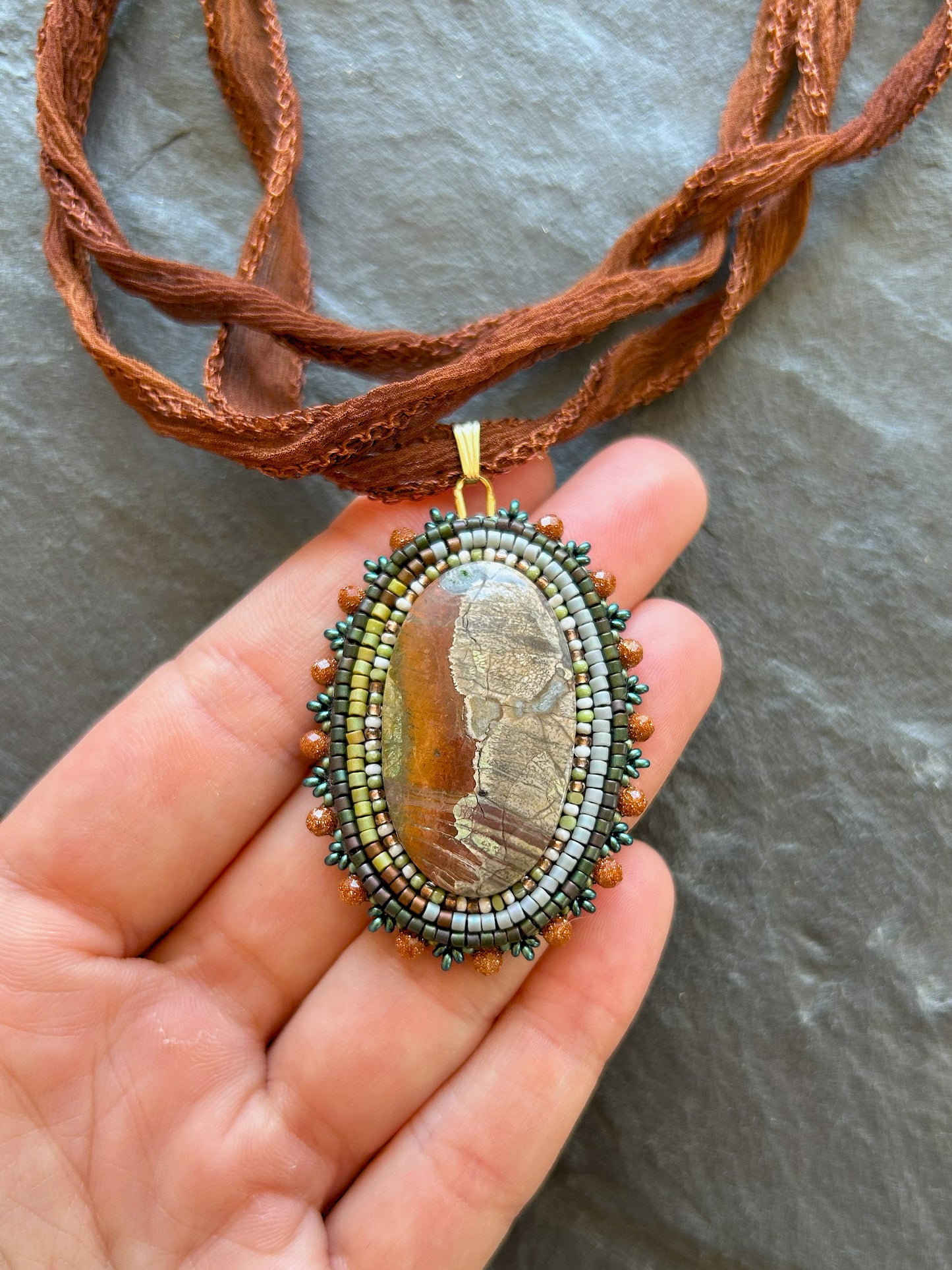 Scenic jasper necklace pendant with goldstone beads