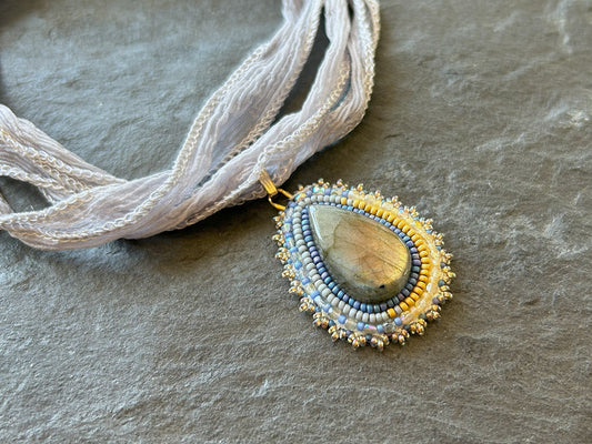 Small labradorite necklace pendant with blue to yellow fire