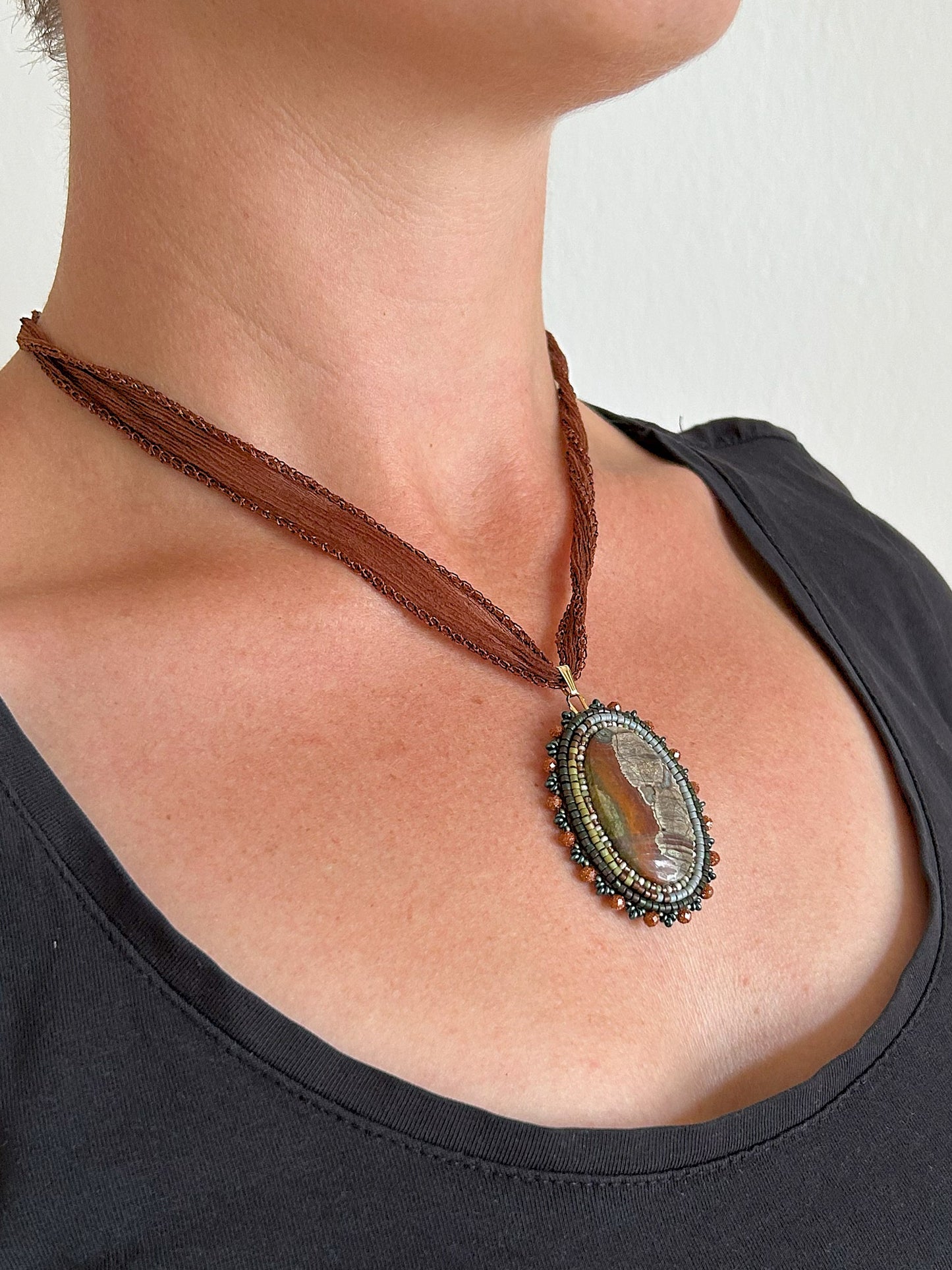 Scenic jasper necklace pendant with goldstone beads