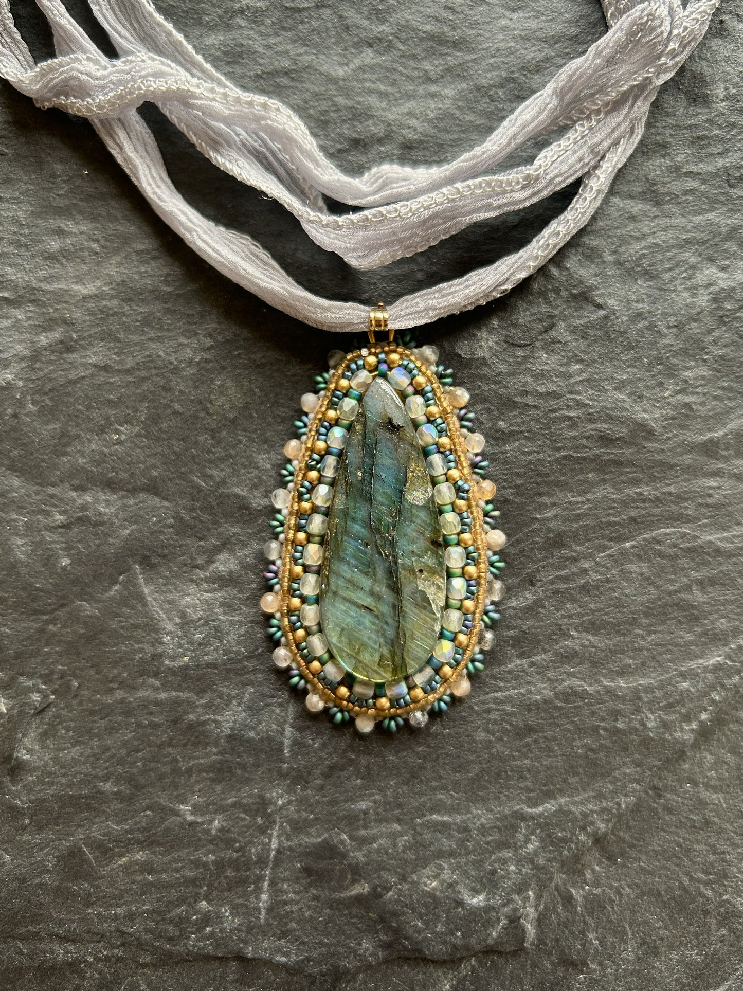 Striped labradorite necklace pendant with deep blue fire