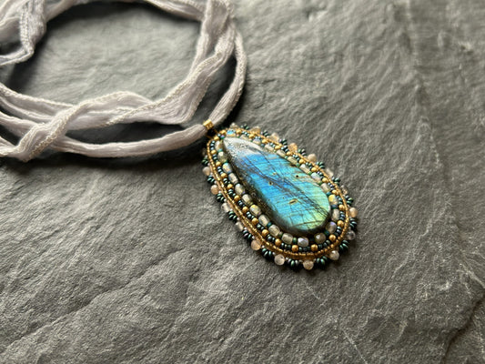 Striped labradorite necklace pendant with deep blue fire