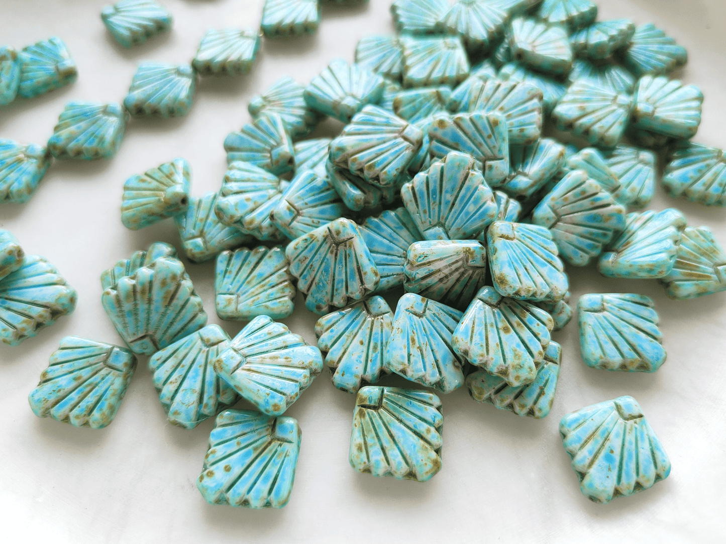 Fan ornament beads 17mm - light blue & brown speckled