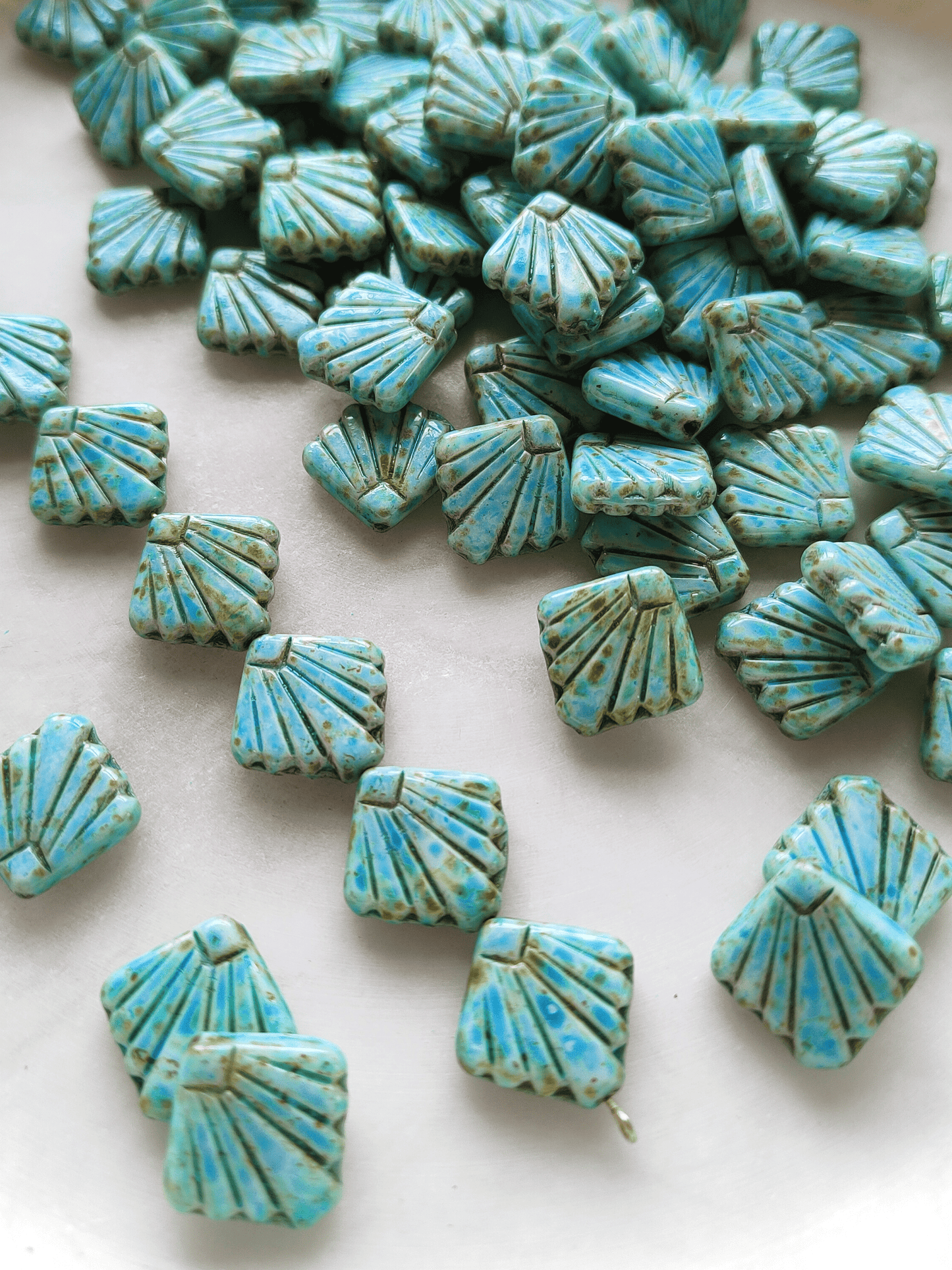 Fan ornament beads 17mm - light blue & brown speckled