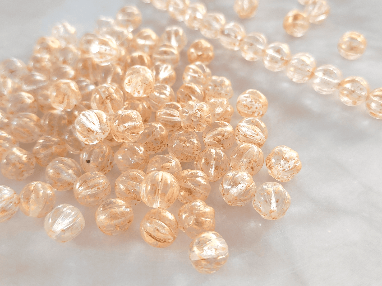 Melon beads 8mm - colorless & gold speckles