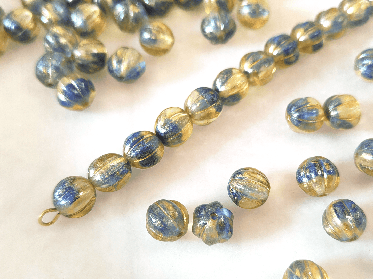 Melon beads 8mm - colorless, dark blue & gold glitter