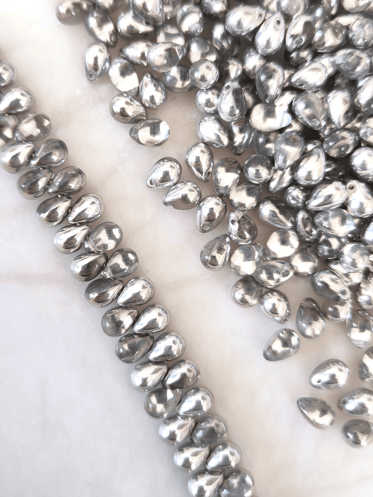 Drop beads 5x7mm - half silver