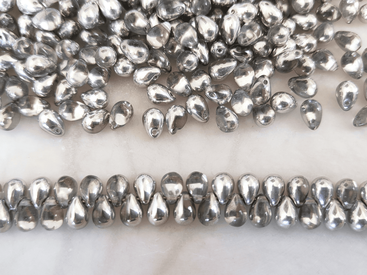Drop beads 5x7mm - half silver