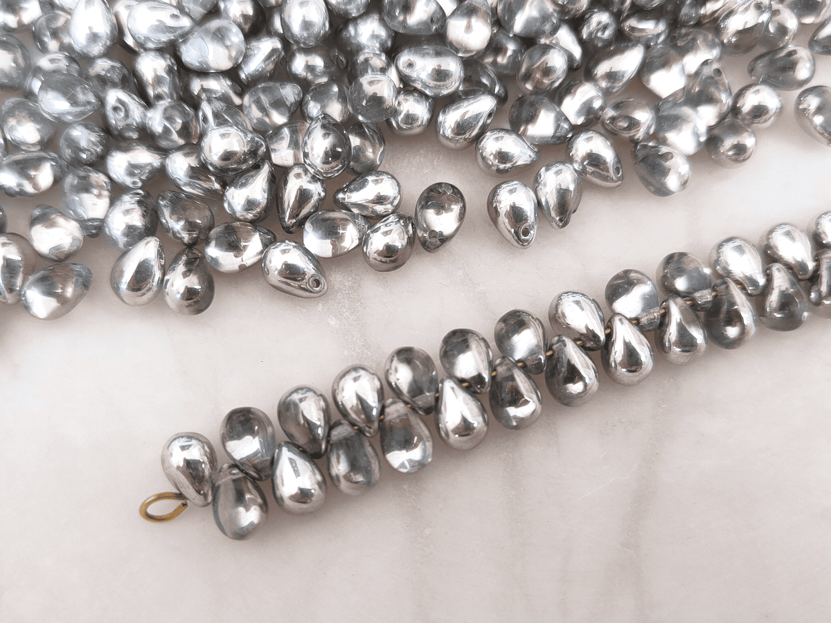 Drop beads 5x7mm - half silver