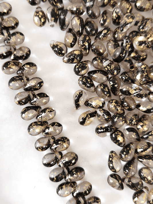 Drop beads 6x9mm - colorless, dark purple & golden speckles