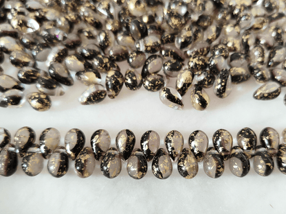 Drop beads 6x9mm - colorless, dark purple & golden speckles