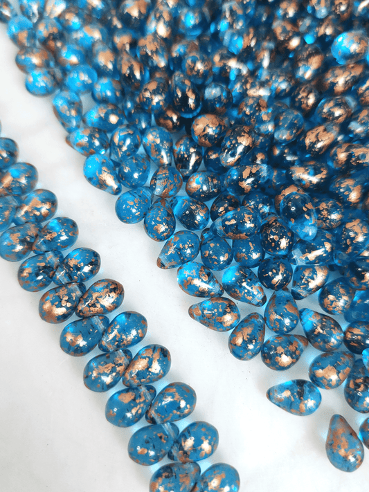Drop beads 6x9mm - Caribbean blue & copper speckles