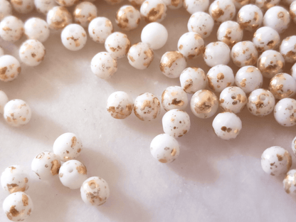 4mm round beads - white & golden speckles