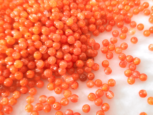 4mm round beads - colorless & orange
