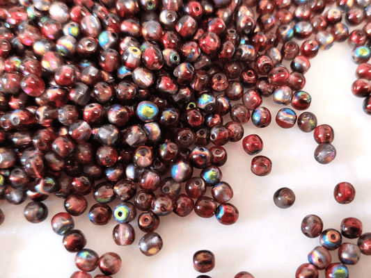 4mm round beads - colorless & metallic red